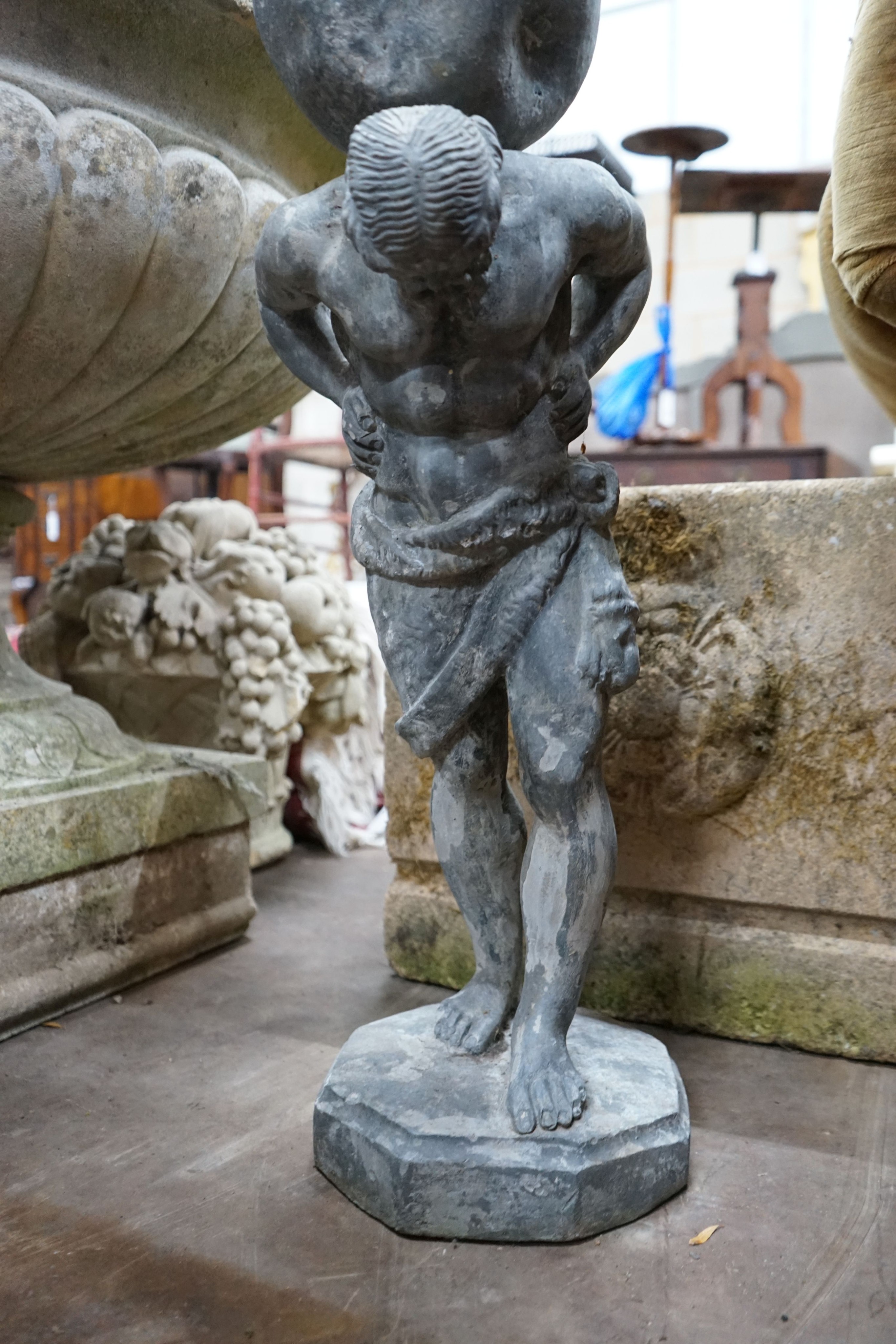 A small weathered lead garden ornament of Atlas, height 74cm